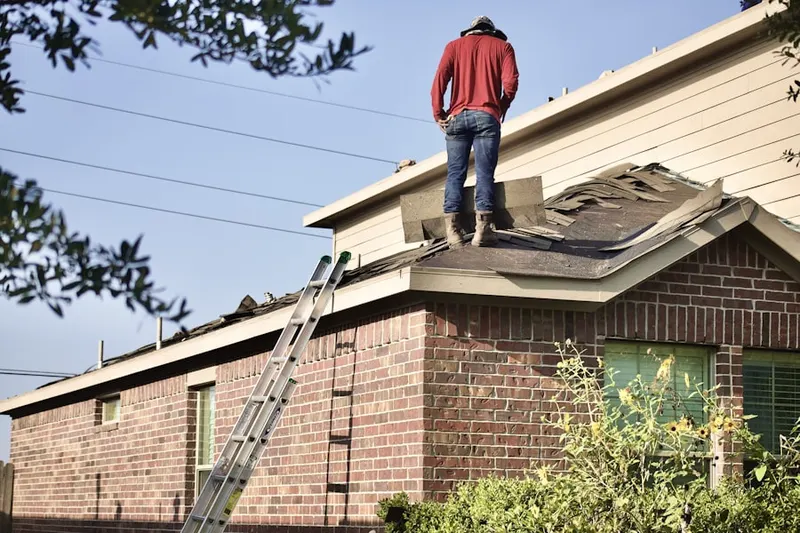 Professional roofer working on a residential roof in Timberwood Estates